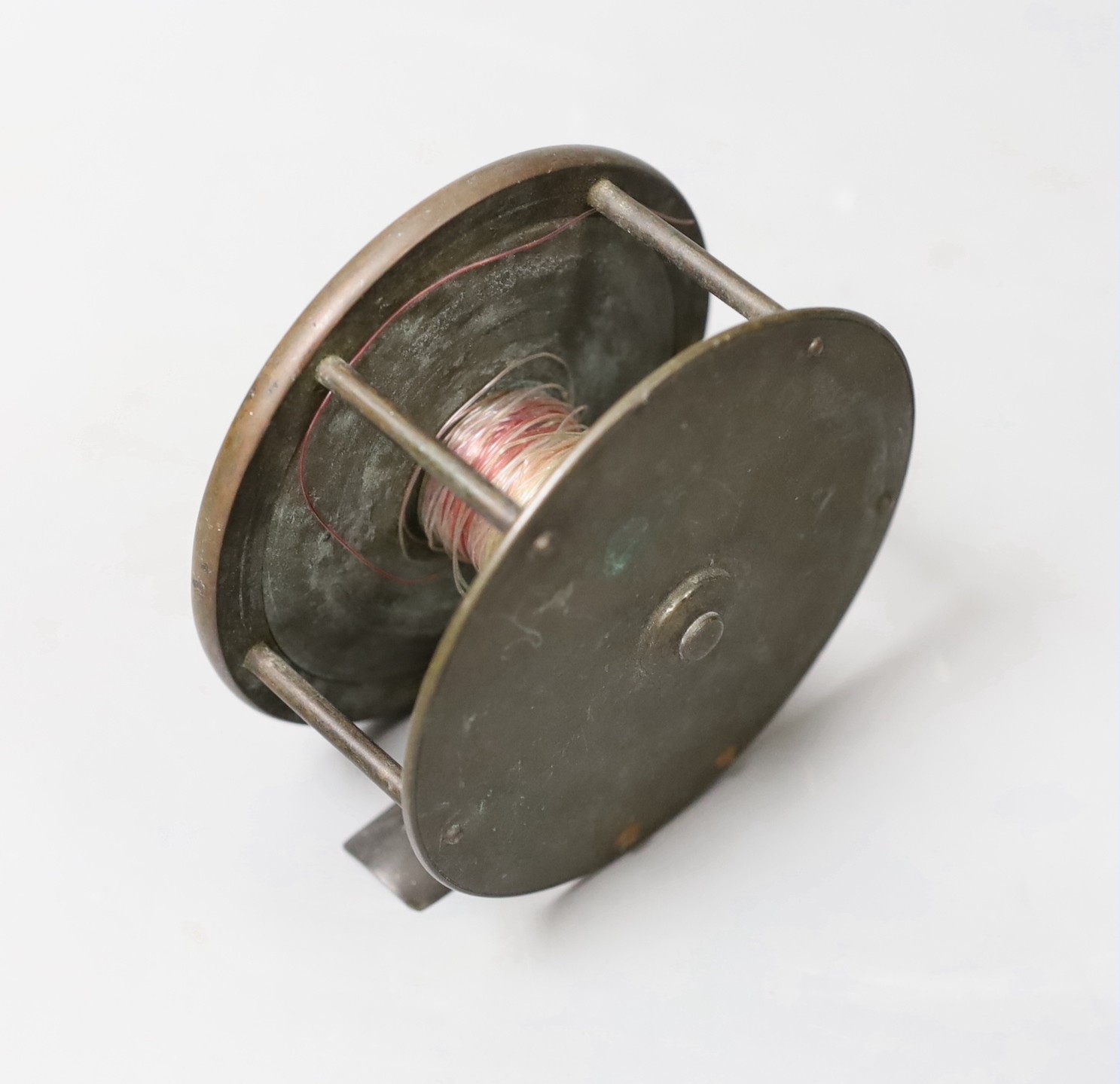 A vintage fishing reel, marked ‘A H N.C.S.L 117 Victoria S.S.W’